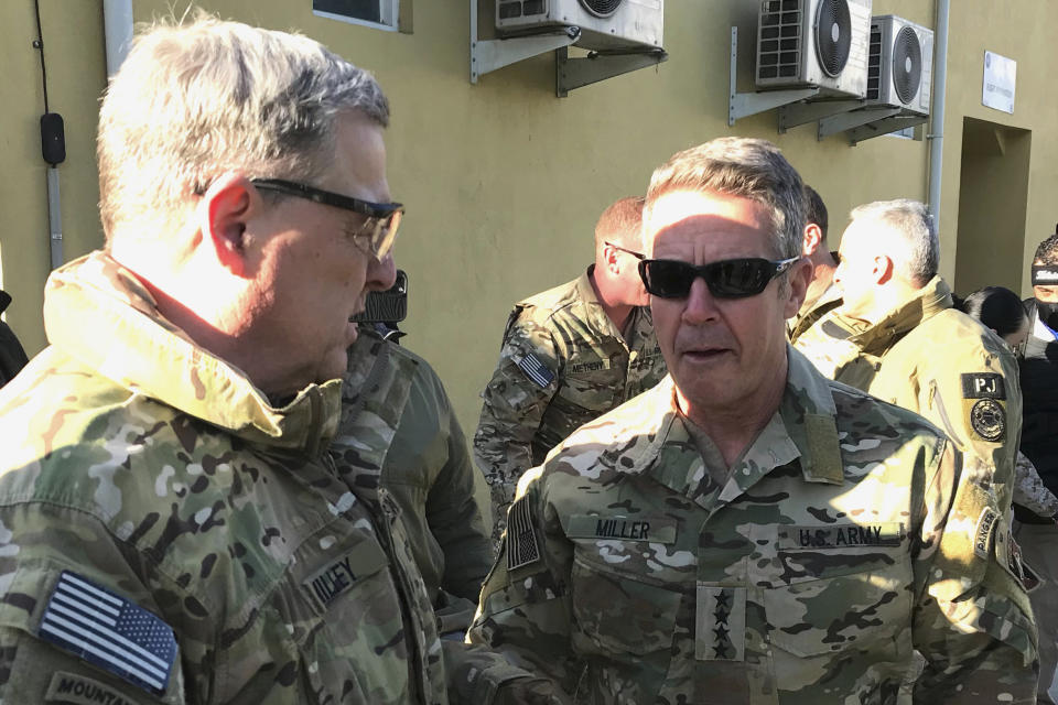 Chairman of the U.S. Joint Chiefs of Staff Gen. Mark Milley, left, talks with Gen. Scott Miller, the commander of U.S. and coalition forces in Afghanistan, Wednesday, Dec. 16, 2020 at Miller’s military headquarters in Kabul, Afghanistan. The top U.S. military officer has held an unannounced meeting with Taliban peace negotiators to push for a reduction in violence in Afghanistan. (AP Photo/Robert Burns)