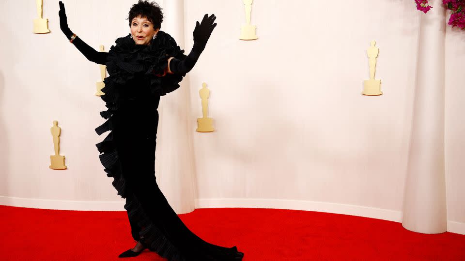 Ninety-two-year-old actor Rita Moreno wore a black hour-glass gown by designer label Badgley Mischka and a pair elegant evening gloves. - Sarah Meyssonnier/Reuters