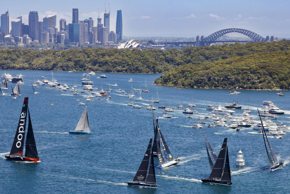In this photo provided by ROLEX, boats sail towards the heads soon after the the start of the Sydney Hobart yacht race on Sydney Harbour, Australia, Monday, Dec. 26, 2022. (Carlo Borlenghi/ROLEX via AP)