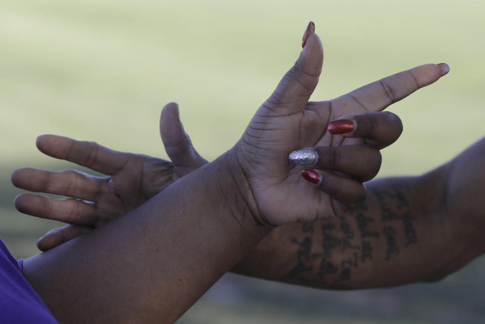 Nicey Brown and Kevin Bryant discusses the impeachment inquiry into President Donald Trump walking in a park, Wednesday, Oct. 9, 2019, in Fishers, Ind. (AP Photo/Darron Cummings)