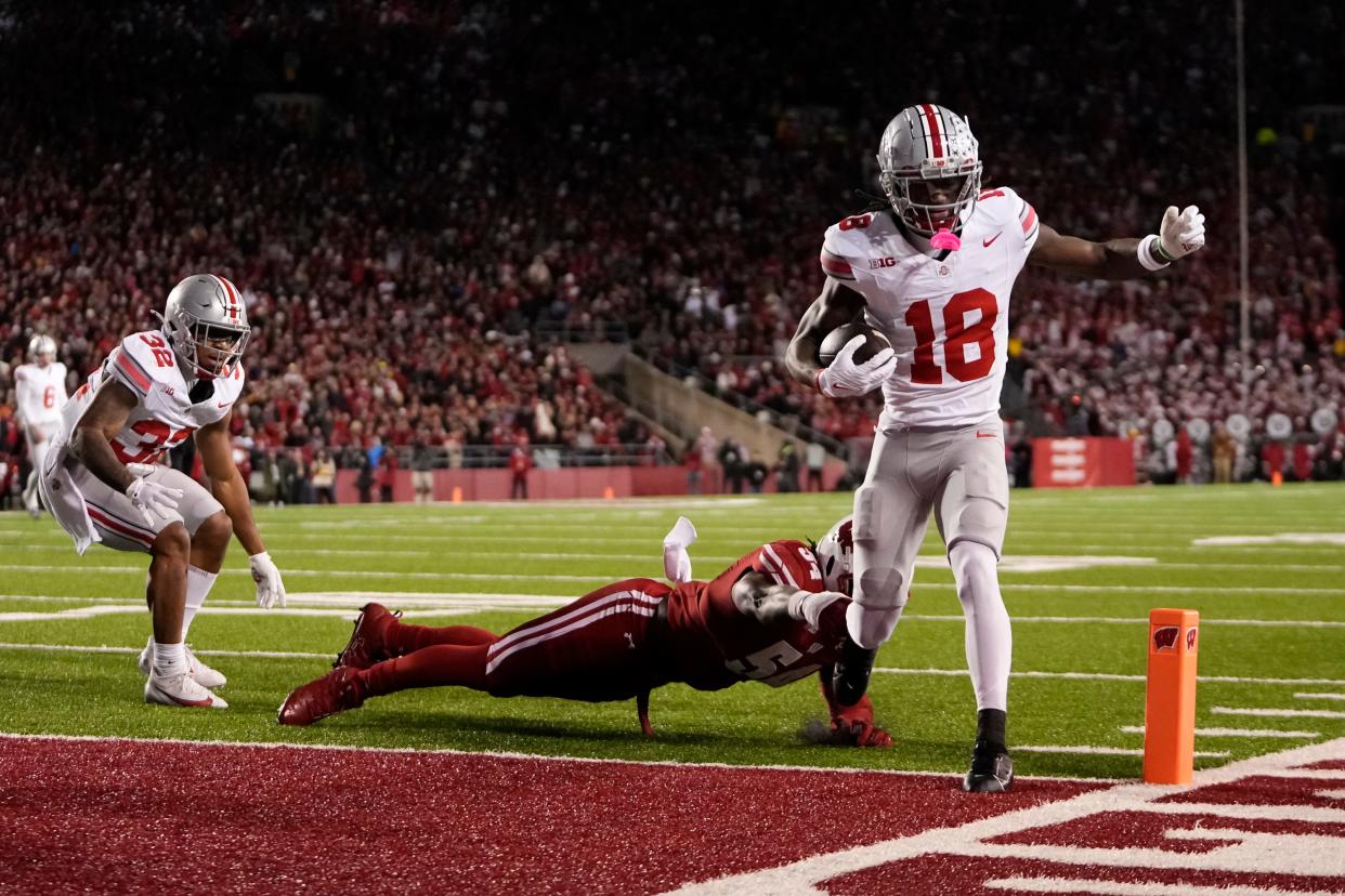 Ohio State receiver Marvin Harrison Jr. scores a touchdown in front of Wisconsin linebacker Jordan Turner on Saturday.