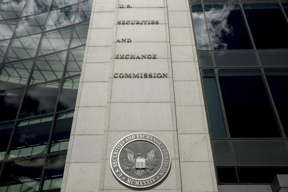 FILE - In this Aug. 5, 2017, file photo U.S. Securities and Exchange Commission building in Washington. Securities and Exchange Commission employees have been told to work remotely for the foreseeable future after a coronavirus scare at the agency's Washington headquarters. The agency, said it was informed Monday, March 9, 2020, that a headquarters employee had received medical treatment for respiratory symptoms earlier in the day. (AP Andrew Harnik, File)