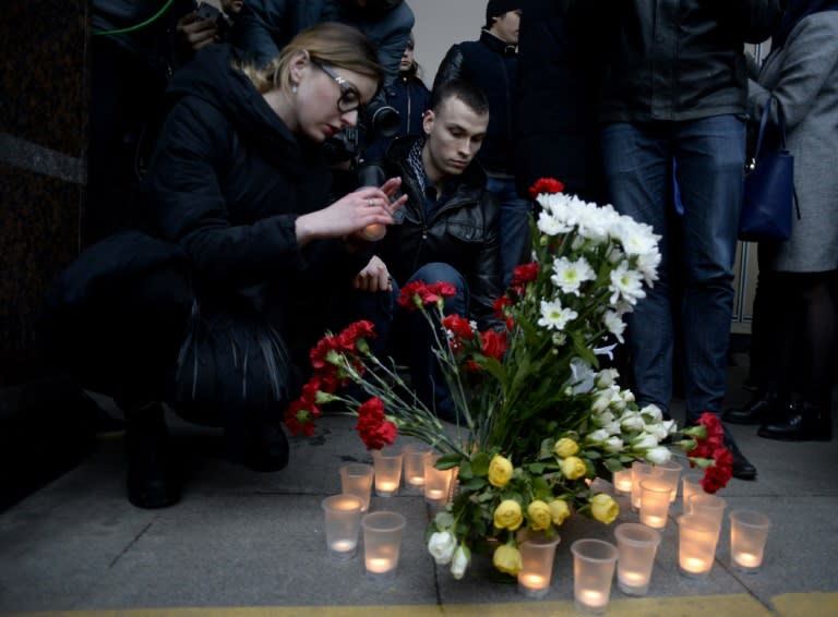 People place flowers and lit candles in memory of victims of the blast in the Saint Petersburg metro outside Sennaya Square station on April 3, 2017