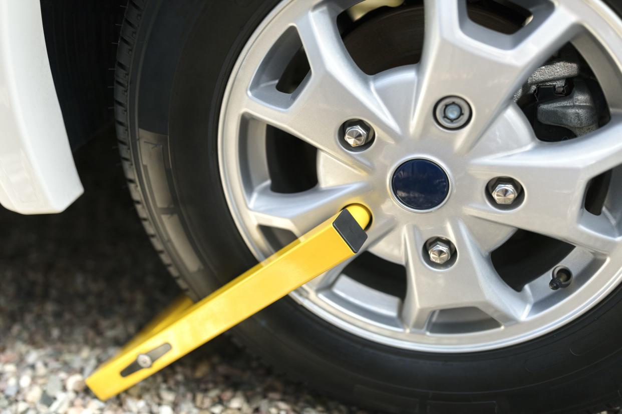 Wheel clamp mounted on vehicle, security device or illegal parking, motorhome, van, car or caravan