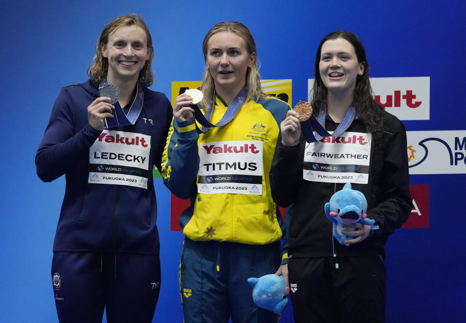 Gold medallist Ariarne Titmus of Australia, center, is flanked by silver medallist Katie Ledecky of the United States, and bronze medallist Erika Fairweather of New Zealand as they pose with their medals after winning Women 400m Freestyle finals at the World Swimming Championships in Fukuoka, Japan, Sunday, July 23, 2023. (AP Photo/Lee Jin-man)