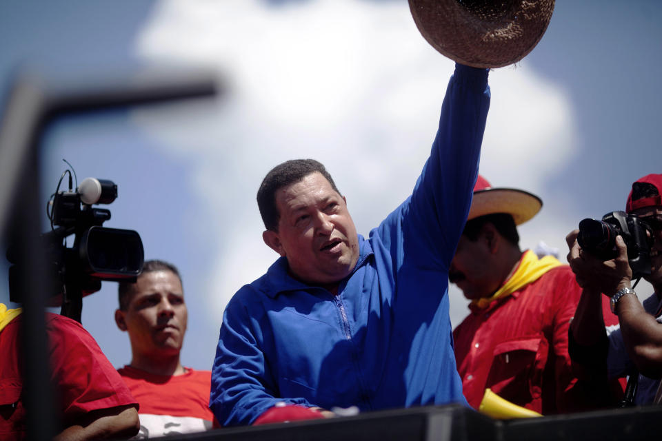 Venezuela's President Hugo Chavez waves to supporters from the top of a vehicle during a campaign caravan from Barinas to Caracas, in Sabaneta, Venezuela, Monday, Oct. 1, 2012. Venezuela's presidential election is scheduled for Oct. 7. (AP Photo/Rodrigo Abd)