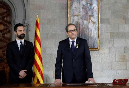 Quim Torra takes his oath as new Catalan Regional President next to regional parliament speaker Roger Torrent during a ceremony at Generalitat Palace in Barcelona, Spain, May 17, 2018. Alberto Estevez/Pool via REUTERS