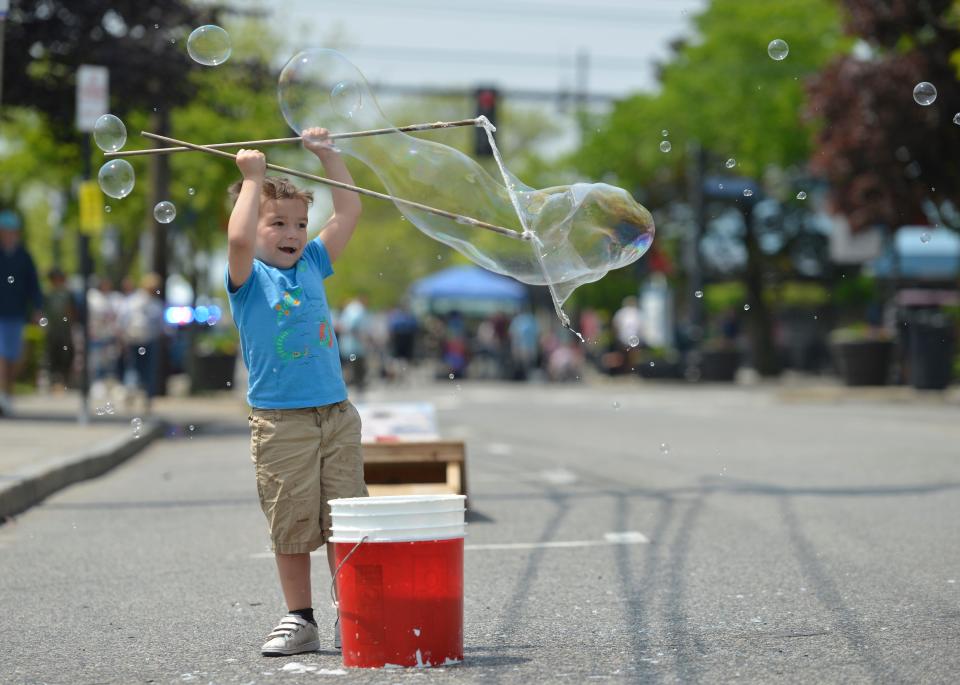 Five-year-old Daniel Coughlin, of Hyannis, makes giant bubbles along Main Street on Sunday afternoon. Coughlin's mother said that they come to every Hyannis Open Streets. 
A section of Main Street was closed to car traffic to make way for pedestrians. Vendors were set up throughout. 
To see more photos, go to www.capecodtimes.com. 
Merrily Cassidy/Cape Cod Times