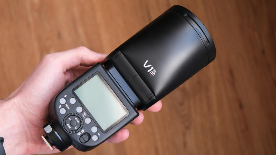 Godox V1Pro flashgun held in a hand