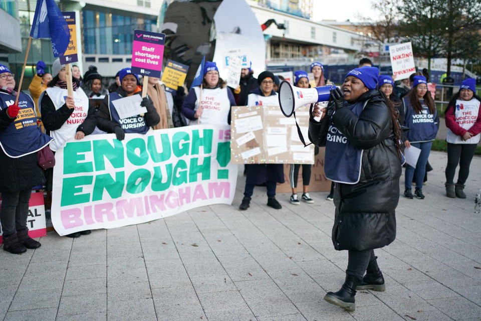 Members of the Royal College of Nursing (RCN) protest as nurses in England, Wales and Northern Ireland take industrial action over pay, outside the Queen Elizabeth Hospital in Birmingham, England, Tuesday, Dec. 20, 2022. (Jacob King/PA via AP)