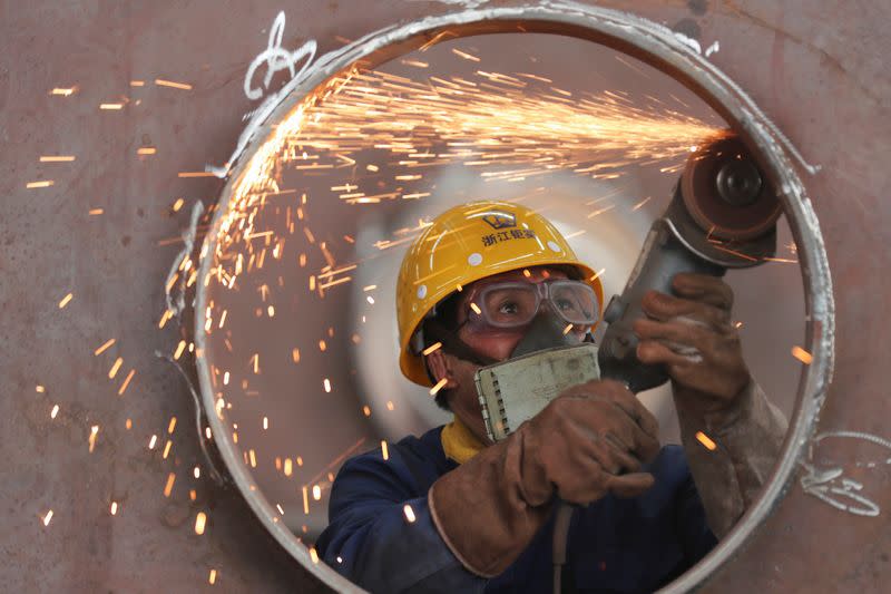 Employee works on a production line manufacturing steel structures at a factory in Huzhou