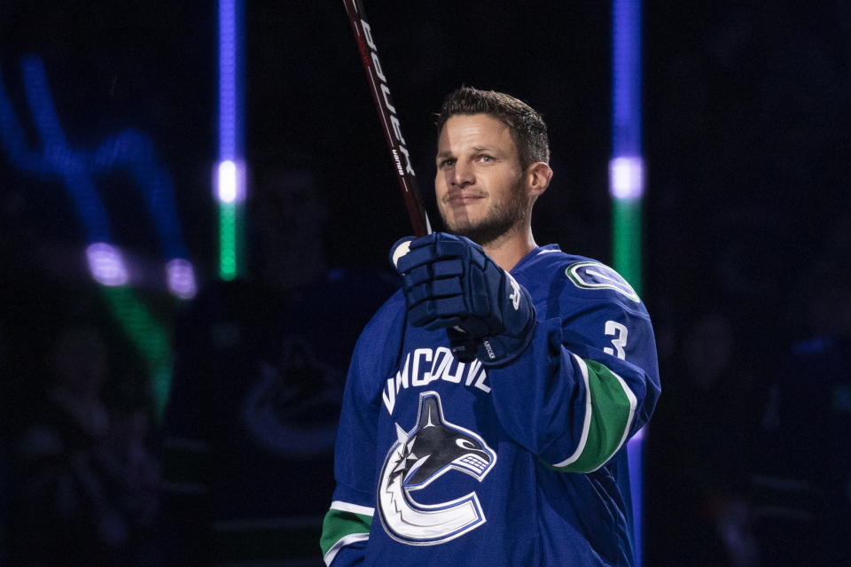 Former Vancouver Canucks player Kevin Bieksa is honored before the team's NHL hockey game against the Anaheim Ducks on Thursday, Nov. 3, 2022, in Vancouver, British Columbia. Bieksa signed a one-day contract with the Canucks to officially retire. (Ben Nelms/The Canadian Press via AP)