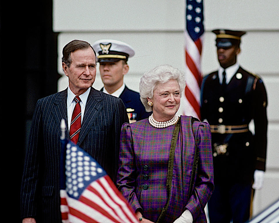 Barbara Bush stands next to President George H.W. Bush outside the South Portico diplomatic entrance to the White House as they wait the arrival of Prime Minister Anibal Cavacu Silva of Portugal on Jan. 11, 1990.