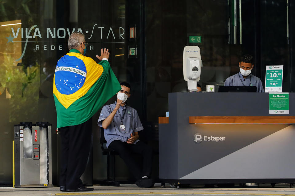 A supporter of Brazilian President Jair Bolsonaro, retired professor of history and geography Antonio Ortega, arrives to Vila Nova Star hospital to deliver a letter to the president who is hospitalized in Sao Paulo, Brazil, Monday, Jan. 3, 2022. Bolsonaro is at the hospital Monday for tests after experiencing abdominal discomfort and is in stable condition, according to a hospital statement. (AP Photo/Marcelo Chello)