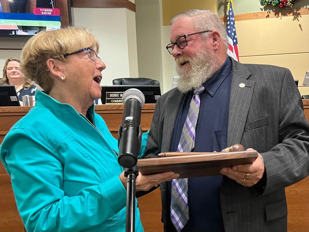 New North Port Mayor Barbara Langdon gives Pete Emrich a plaque with a gavel, as recognition for his service as mayor for this past year, at a special meeting that served as both the certification of the Nov. 2022 election results and swearing in of new city commissioners.