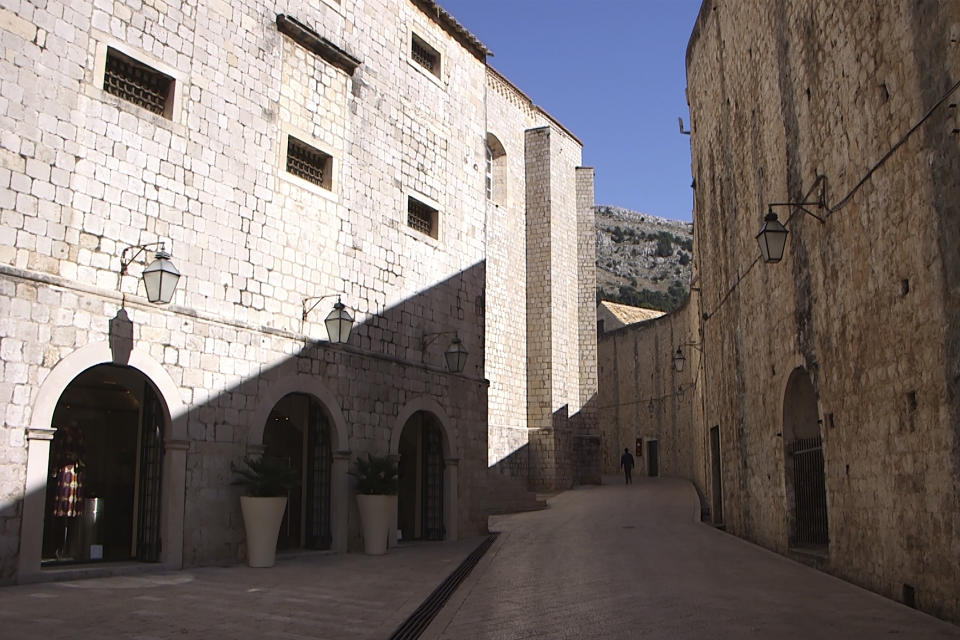 This Tuesday, March 17, 2020 photo shows deserted street and the city walls in Dubrovnik old town, Croatia. Just outside the majestic walls of Croatia’s medieval citadel city of Dubrovnik lies a cluster of small stone houses that today serve as an art and clubbing hub. But as the coronavirus spreads across the globe, many are being reminded of the Lazarettos complex, called Lazareti in Croatian, originally use as an ancient quarantine area that helped keep infectious diseases away. (AP Photo/Darko Bandic)