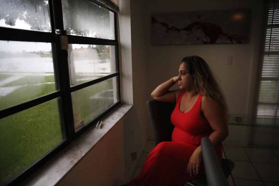 In this Aug. 6, 2019, photo, Barbara Rodriguez poses for a photo in Hialeah, Fla. Her husband, Pablo Sanchez, is seeking asylum in the U.S., but was placed in detention and is now facing deportation to Cuba. The number of Cubans deported from the United States has increased more than tenfold since the end of the Obama administration to more than 800 in the past year. (AP Photo/Brynn Anderson)