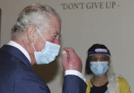 Britain's Prince Charles during a visit to an NHS vaccine pop-up clinic at Jesus House church, London, Tuesday March 9, 2021, where he has been told about work to combat vaccine hesitancy and support for the community during the coronavirus pandemic. (Ian Vogler/Pool via AP)