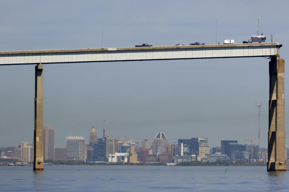 People work on a standing section of the collapsed Francis Scott Key Bridge, Monday, April 15, 2024, in Baltimore. The FBI confirmed that agents were aboard the Dali conducting court-authorized law enforcement activity. (AP Photo/Julia Nikhinson)