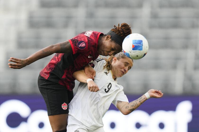 Canada defender Kadeisha Buchanan, left, and Costa Rica forward Maria Paula Salas vie for the ball during the first half of a CONCACAF Gold Cup women's soccer tournament quarterfinal Saturday, March 2, 2024, in Los Angeles. (AP Photo/Ryan Sun)