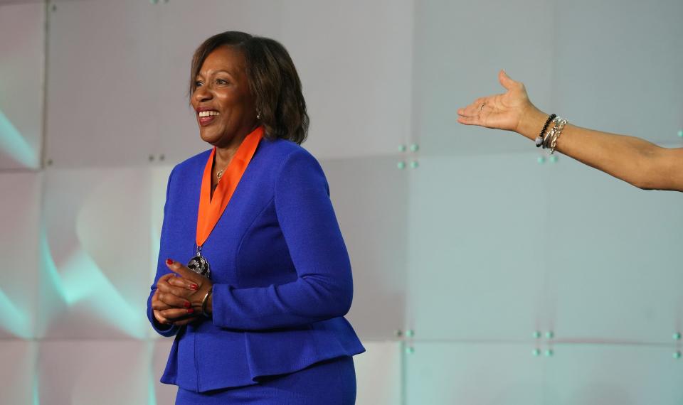 The hand of Congresswoman Joyce Beatty introduces 2024 Woman of Achievement honoree Demetries Neely on Thursday during the 39th YWCA Women of Achievement celebration.