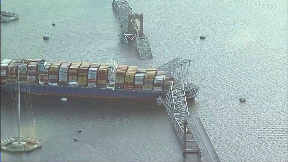 Parts of the Francis Scott Key Bridge remain after a container ship collided with a support Tuesday, March 26, 2024 in Baltimore. The major bridge in Baltimore snapped and collapsed after a container ship rammed into it early Tuesday, and several vehicles fell into the river below. Rescuers were searching for multiple people in the water. (WJLA via AP)