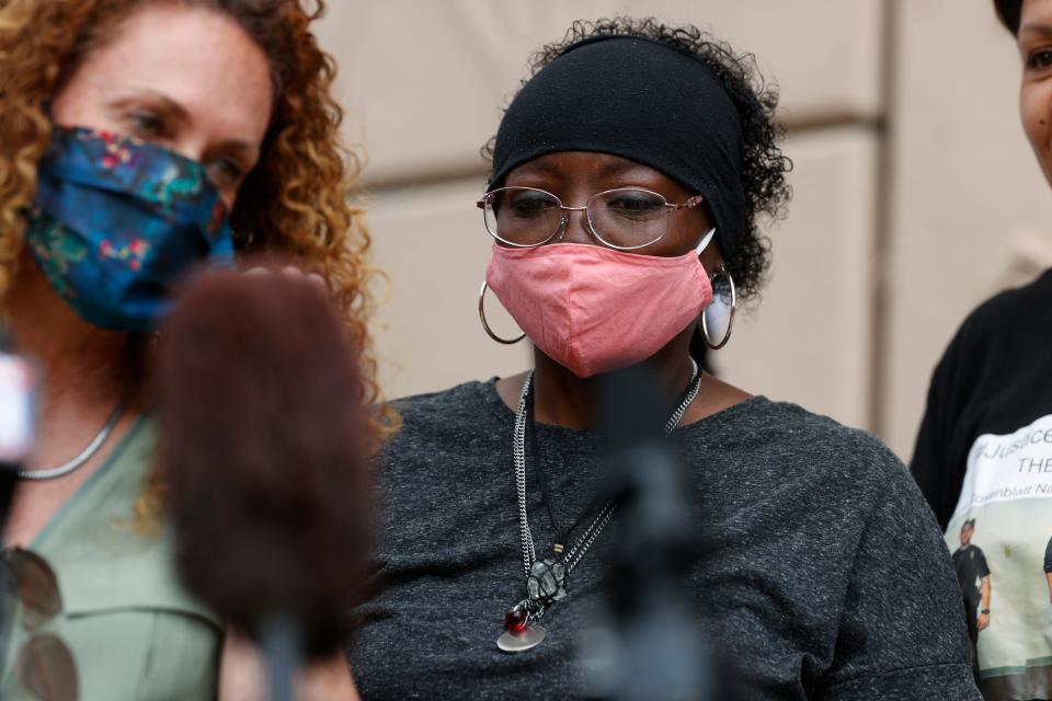 Sheneen McClain, right, and family attorney Mari Newman speak during a news conference at the memorial site across the street from where McClain's 23-year-old son, Elijah, was stopped by police officers, in Aurora, Colorado.