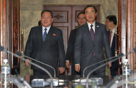 South Korean Unification Minister Cho Myoung-gyon and his North Korean counterpart Ri Son Gwon arrive for their meeting at the truce village of Panmunjom, North Korea, March 29, 2018. Korea Pool/Yonhap via REUTERS