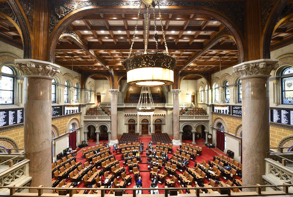 FILE - Members of the New York Assembly debate budget bills at the State Capitol, Wednesday, April 7, 2021, in Albany, N.Y. Gov. Andrew Cuomo, buffeted by sexual harassment allegations, is increasingly looking like he could be impeached and removed from office. A majority of members of the state Assembly, the legislative body that has the power to start impeachment proceedings, have already said they favor removing Cuomo if he won't resign. (AP Photo/Hans Pennink, File)