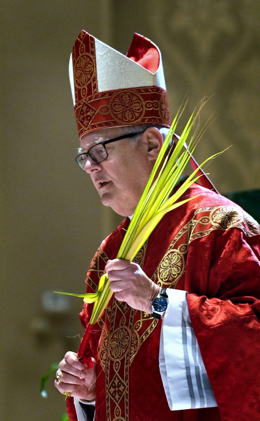 Bishop Thomas J. Tobin celebrates Palm Sunday Mass last year. Rhode Island Catholics must send a written request to the diocese for a dispensation to eat meat on St. Patrick's Day, which falls on Friday this year.