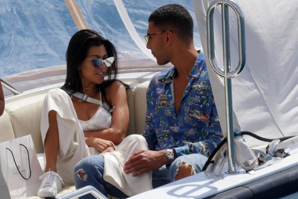 Kourtney and her man are seen getting cosy in a private yacht.