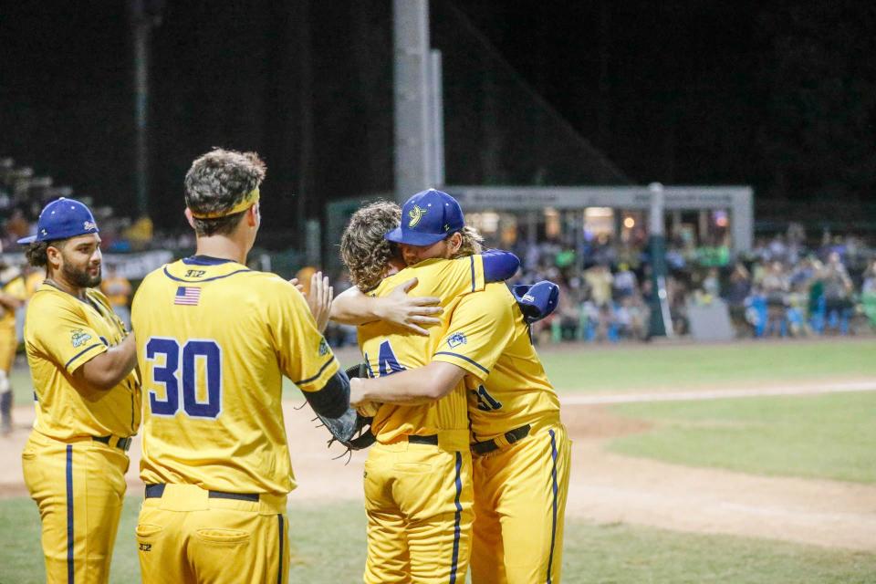 Savannah Bananas pitcher Dylan Cunningham (31) hugs teammates after pitching in his final CPL game on Friday, Aug. 5, 2022, at Grayson Stadium. Cunningham also was on the mound for the final out when the Bananas won the 2021 Petitt Cup championship.