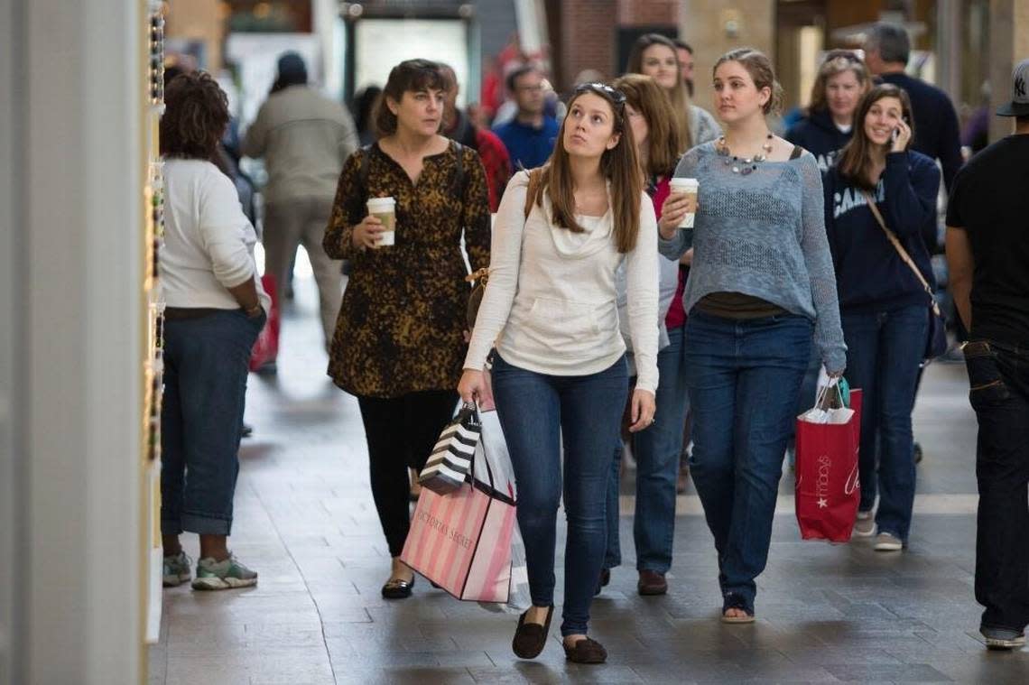 Shoppers walk with arms full of bags on Black Friday, November 27, 2015 at the Streets at Southpoint in Durham, N.C.