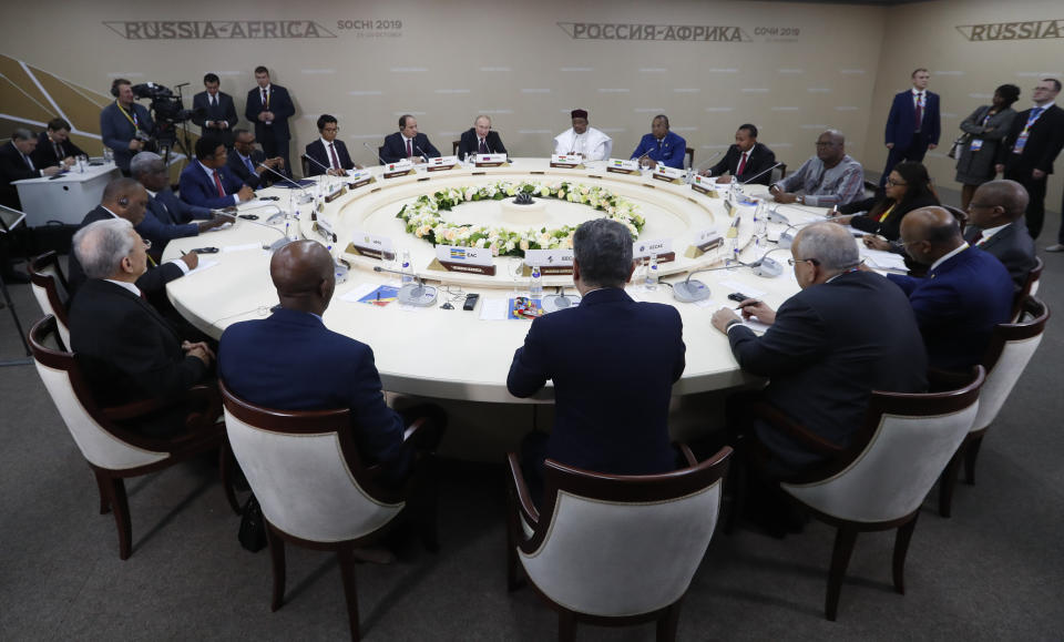 Russian President Vladimir Putin, back centre left, Egyptian President Abdel-Fattah El-Sissi, center second left, and Nigerien President Mahamadou Issoufou, center right, attend a luncheon with the heads of African regional organizations on the sideline of Russia-Africa summit in the Black Sea resort of Sochi, Russia, Wednesday, Oct. 23, 2019. (AP Photo/Sergei Chirikov, pool photo via AP)
