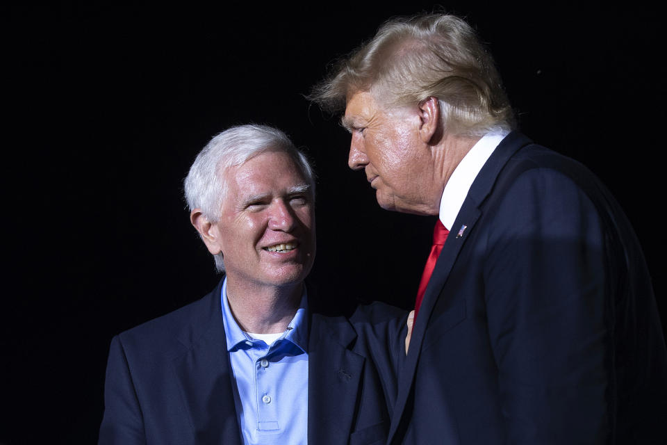 Donald Trump listens to pleasantries from Rep. Mo Brooks.