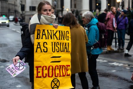 An Extinction Rebellion volunteer protests to highlight the role of banks in financing fossil fuel projects undermining the 2015 Paris Agreement to curb climate change, in London