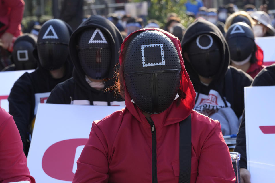 Members of the South Korean Confederation of Trade Unions wearing masks and costumes inspired by the Netflix original Korean series “Squid Game” attend a rally demanding job security in Seoul on Oct. 20. - Credit: AP