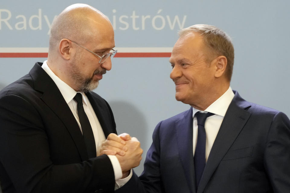 Ukrainian Prime Minister Denys Shmyhal, left, and Poland's Prime Minister Donald Tusk greet each other after making statements to the media following talks in Warsaw, Poland, Thursday, March 28, 2024. The prime ministers of Ukraine and Poland said they made progress Thursday toward meeting demands of Polish and western European farmers who want restrictions on cheap Ukrainian food imports that they say undermine their livelihoods, but they announced no breakthrough. (AP Photo/Czarek Sokolowski)