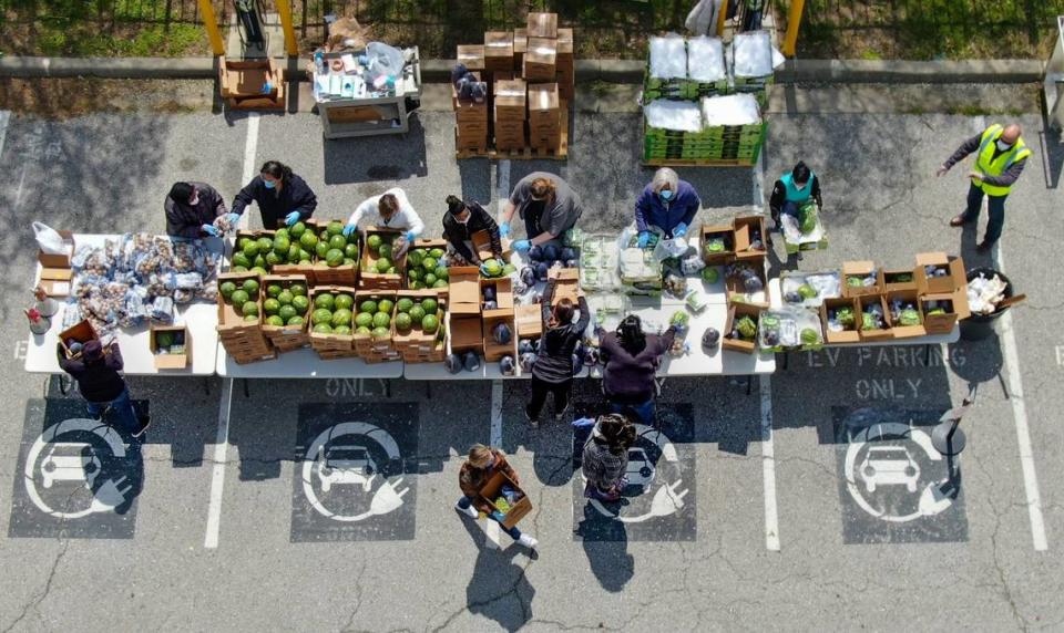 Employees at the Kansas City Health Department sorted more than 4,000 pounds of fresh fresh for distribution at a pop-up market for people in drive-thru and walk-up lines Tuesday, April 15, 2020, in their parking lot. The food, which was provided by Harvesters Community Food Network, was free to anyone who showed up for the market. The pop-up market happens on the second Tuesday of the month at the Health Department. For more food assistance locations and information, go to harvesters.org. 
CORONAVIRUSKC 