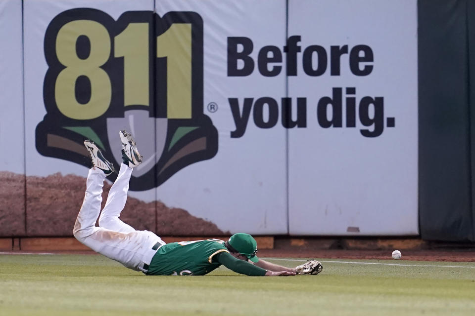 Oakland Athletics right fielder Stephen Piscotty cannot catch an RBI-double by Texas Rangers' Marcus Semien during the seventh inning of a baseball game in Oakland, Calif., Saturday, July 23, 2022. (AP Photo/Jeff Chiu)