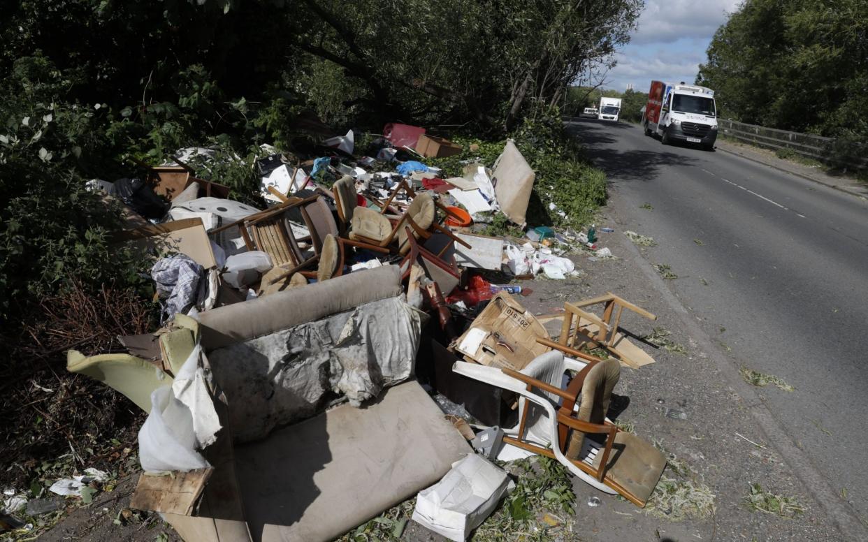  Fly-tipped rubbish and waste beside a road in Colnbrook, west London last year - ADRIAN DENNIS /AFP