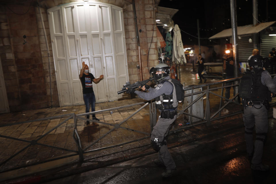 Israeli police officers aims his rifle during clashes with Palestinians near Damascus Gate just outside Jerusalem's Old City, Sunday, May 9, 2021. Israeli police have been clashing with Palestinian protesters almost nightly in the holy city's worst religious unrest in several years. (AP Photo/Ariel Schalit)