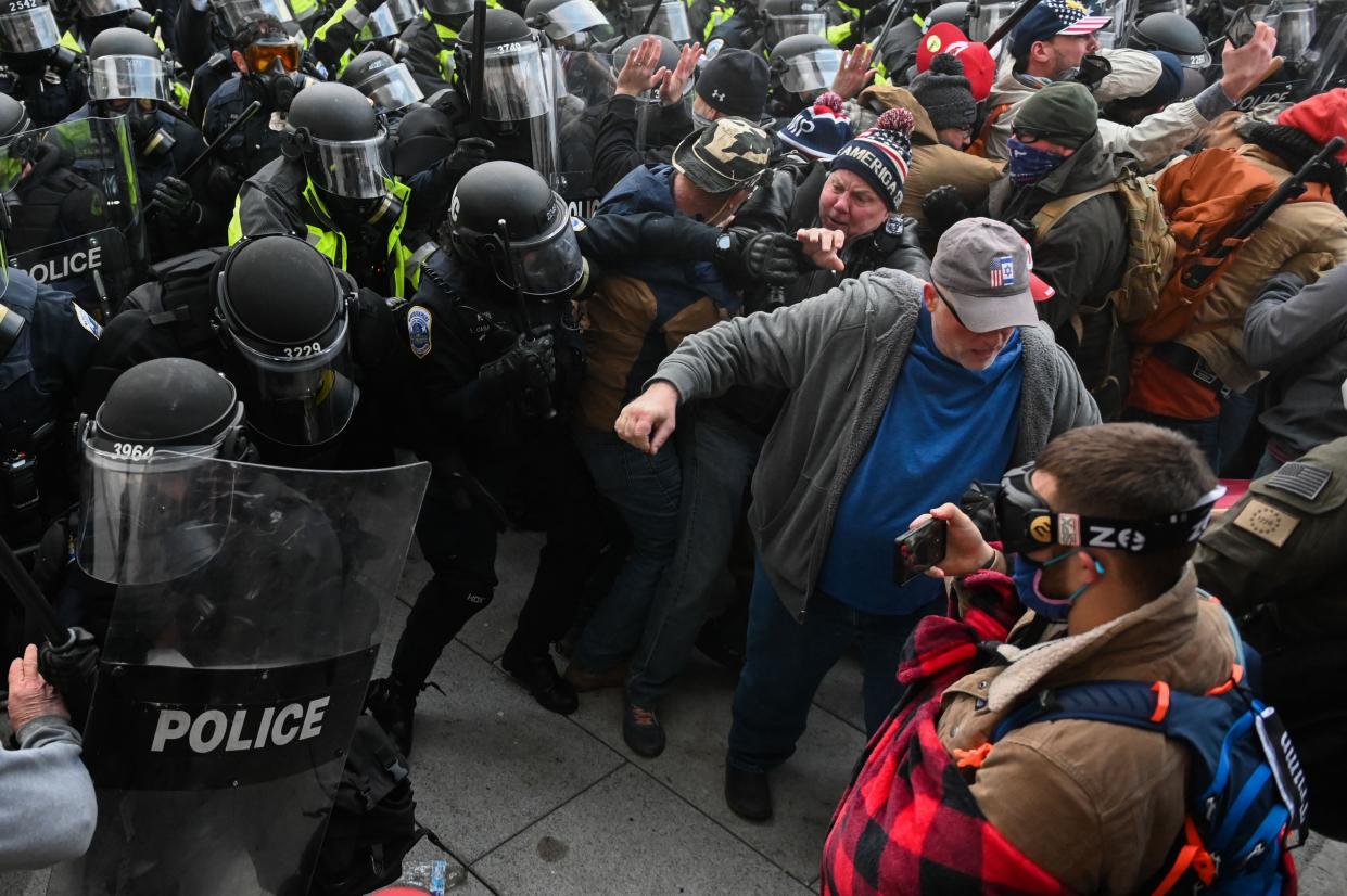 Riot police push back a crowd of supporters of then-President Donald Trump after they stormed the Capitol building on January 6, 2021 in Washington, DC.