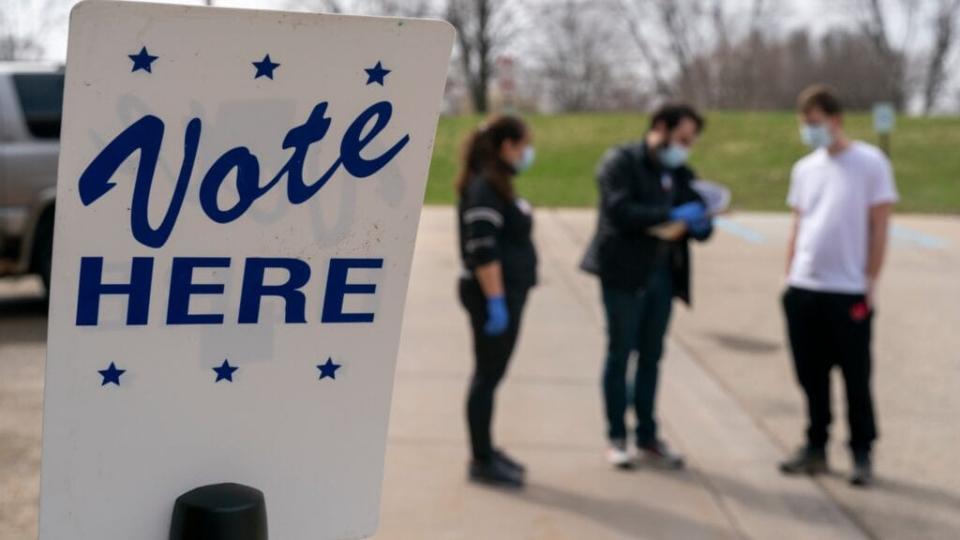 Poll workers in Madison, Wisconsin convene during curbside voting in April. Because of COVID-19, the number of polling places across the nation has been drastically reduced, but the U.S. Supreme Court has struck down curbside voting in Alabama. (Photo by Andy Manis/Getty Images)