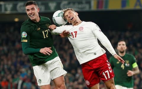 Ireland's Ciaran Clark and Denmark's Jens Stryger Larsen battle for the ball - Credit: action images