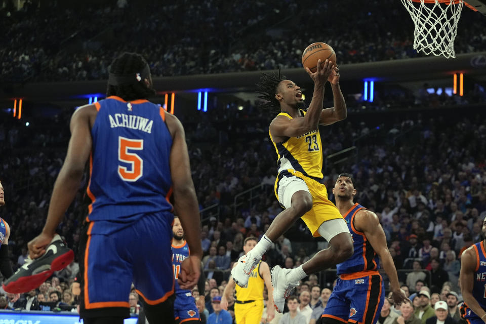 Indiana Pacers' Aaron Nesmith (23) drives past New York Knicks' Josh Hart and Precious Achiuwa (5) during the first half of Game 5 in an NBA basketball second-round playoff series, Tuesday, May 14, 2024, in New York. (AP Photo/Frank Franklin II)