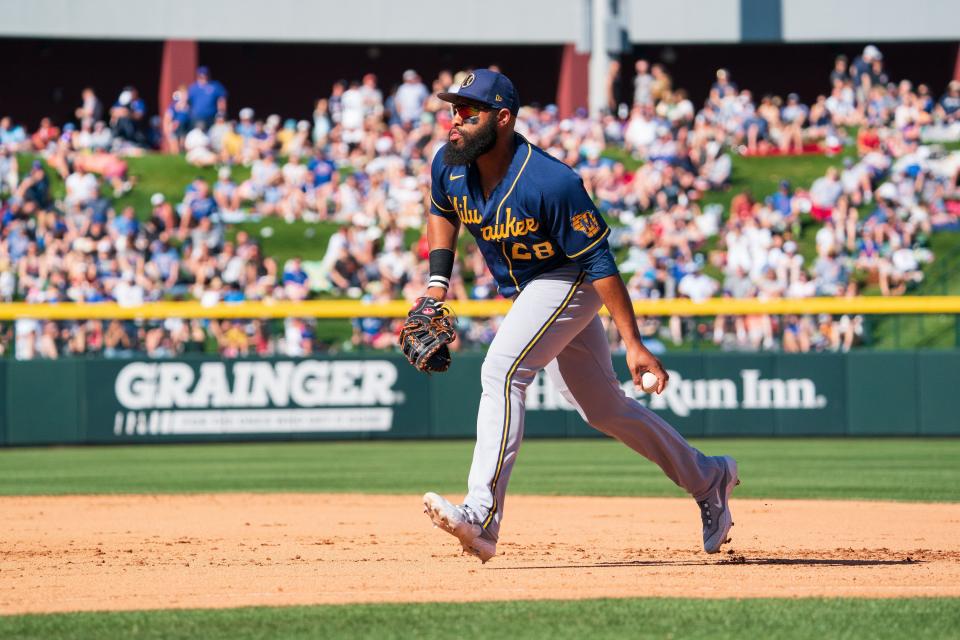 Milwaukee Brewers infielder Jon Singleton (28) looks to toss the ball to first base to make the out in the seventh inning during a spring training game against the Chicago Cubs at Sloan Park.  Mandatory Credit: Allan Henry-USA TODAY Sports.