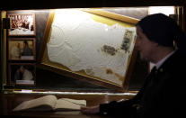 Sister Amelia from the Daughters of Charity stands in front of the altar Thursday, April 10, 2014 where the bloodstained undershirt worn by Pope John Paul II during the assassination attempt on May, 13, 1981, is kept, in Rome. (AP Photo/Gregorio Borgia)