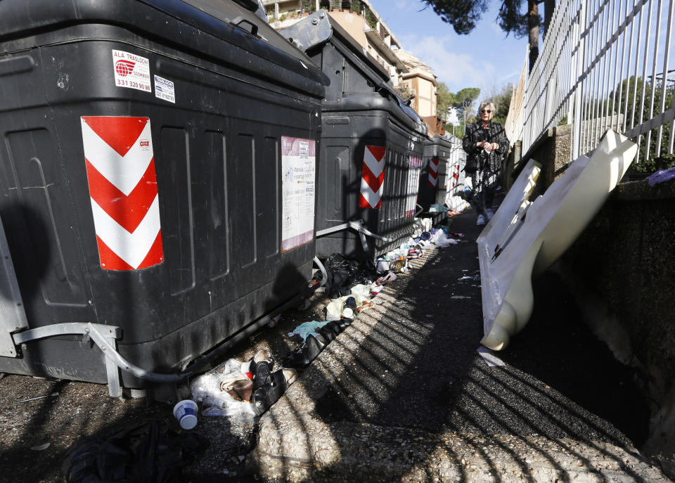 A woman makes her way across a sidewalk covered with uncollected garbage, in Rome, Wednesday, Nov. 7, 2018. Rome’s monumental problems of garbage and decay exist side-by-side with Eternal City’s glories. (AP Photo/Alessandra Tarantino)