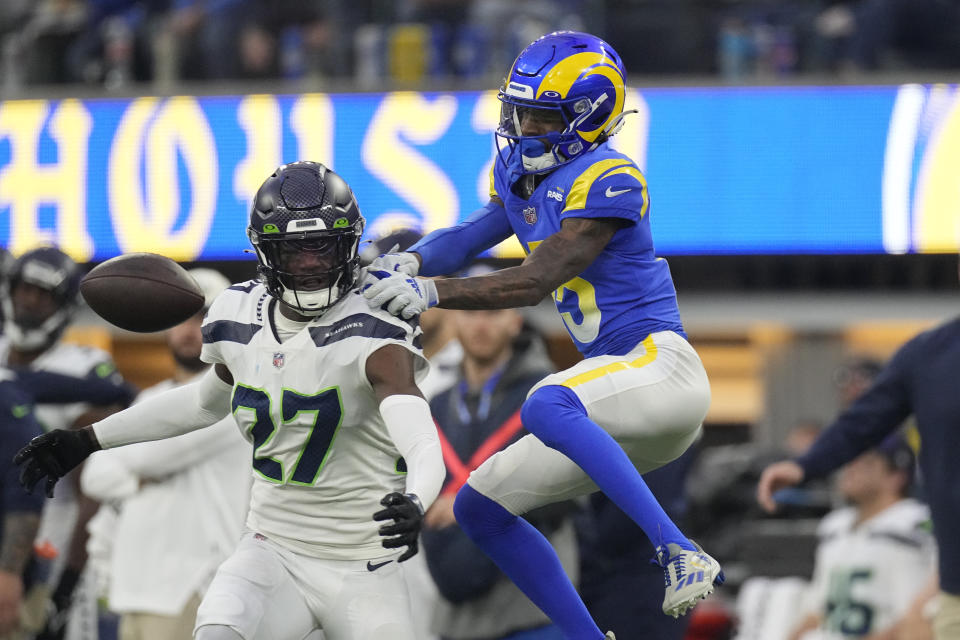 Los Angeles Rams wide receiver Tutu Atwell, right, is unable to catch a pass as Seattle Seahawks cornerback Tariq Woolen (27) defends during the second half of an NFL football game Sunday, Dec. 4, 2022, in Inglewood, Calif. (AP Photo/Mark J. Terrill)